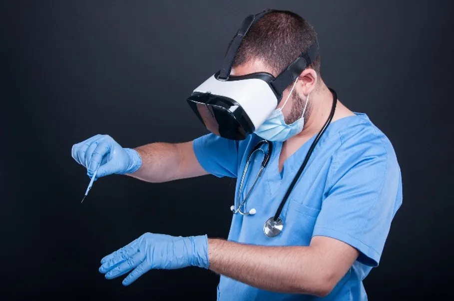 Clinician in scrubs practising a procedure in a VR headset